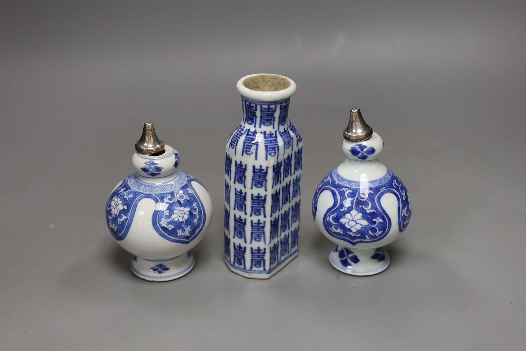 A pair of Chinese Kangxi blue and white rose water sprinklers (cut down) and an unusual 19th century Chinese blue and white ‘Hundred Shou’ jar, rose sprinklers: 10cms high excluding metal tops